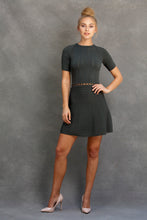 Alexa Fit and Flare Dress - VIAVAI FASHION  FRONT view of a BLOND model with her hair up in a messy bun, IN NUDE HEELS wearing a fit andf flare knit dress in OLIVE color with beautiful textures and open knit details 